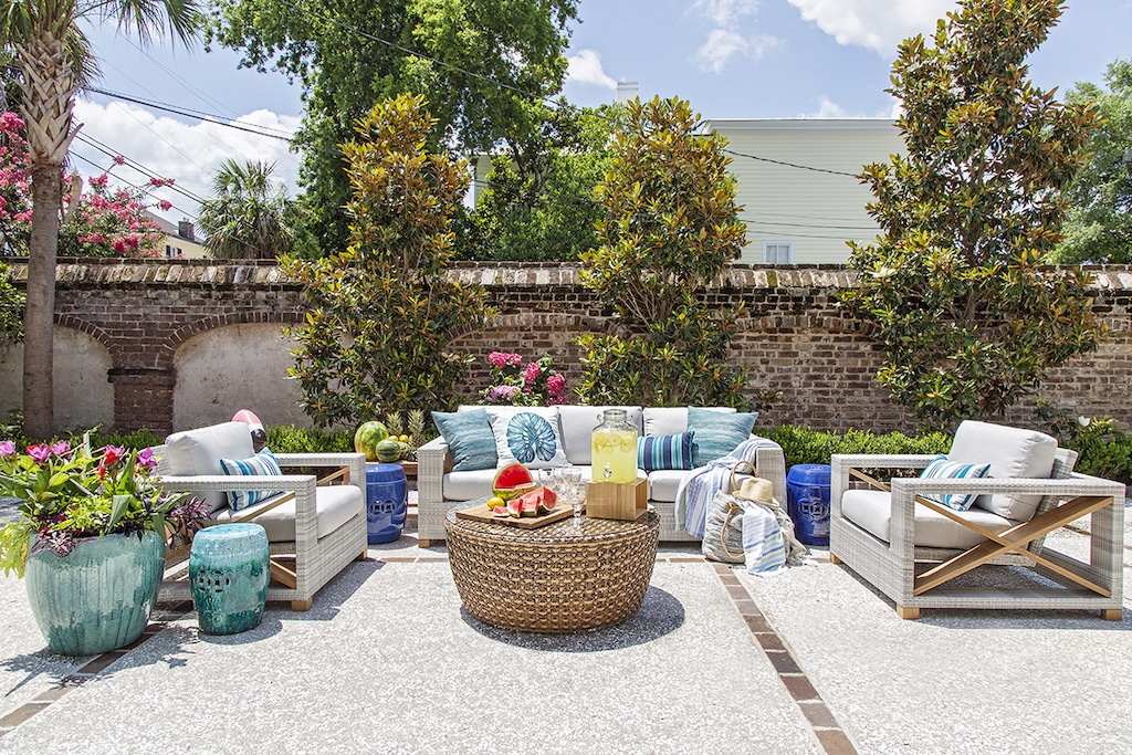 Seating area filled with fruits on table, sofas and cushions in the backyard