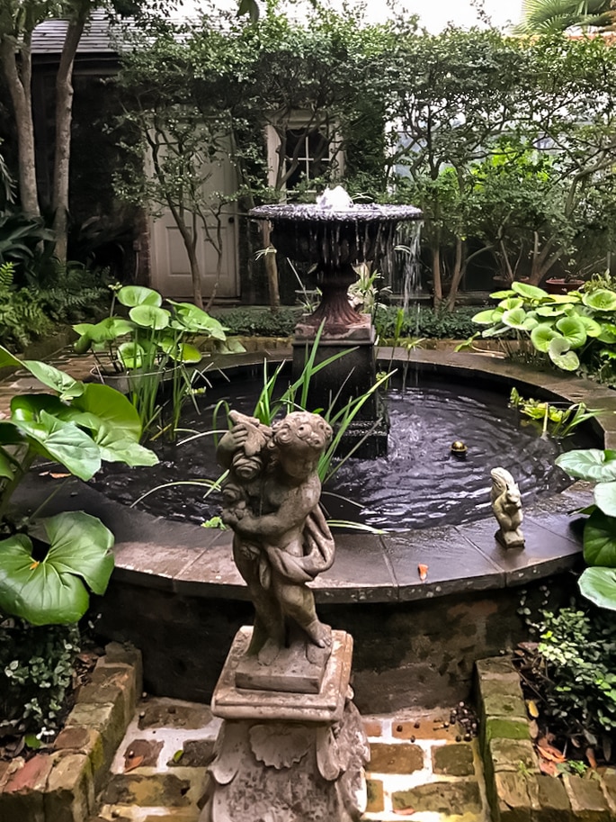 Sculptures in Garden with water fountain and plants