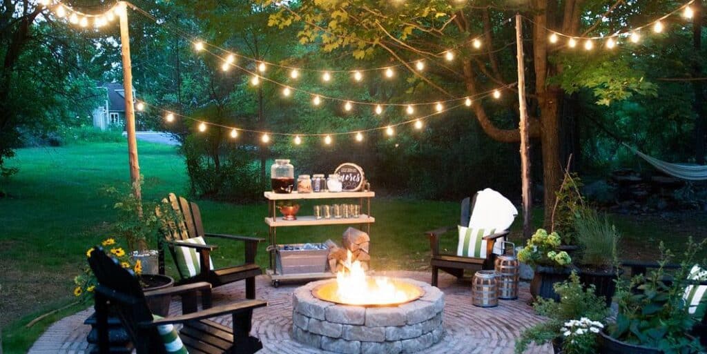 String Lights with classic chairs and a fire pit in the backyard