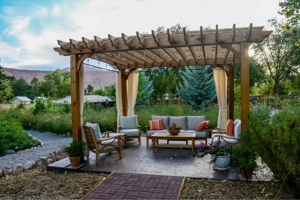 Pergola with sofas and chairs in the outdoor space