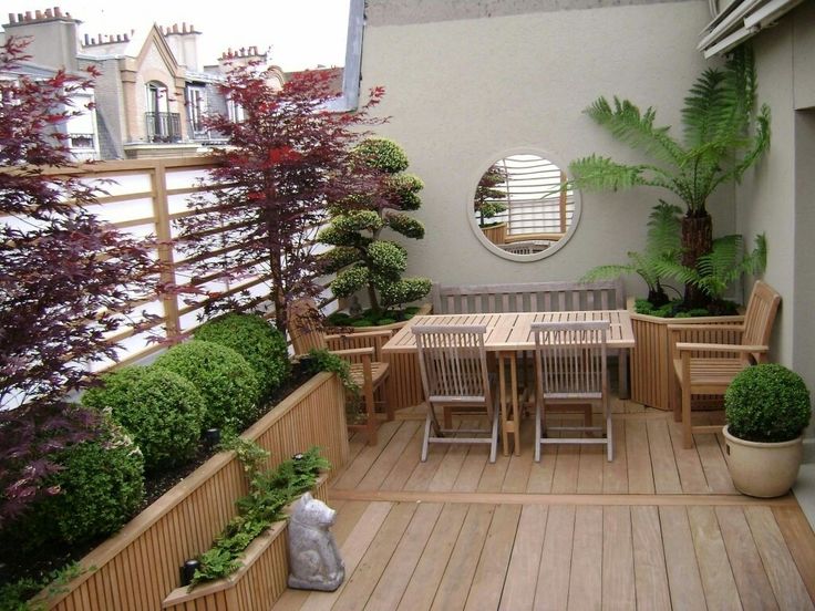 a dining area on a terrace garden having a variety of plants