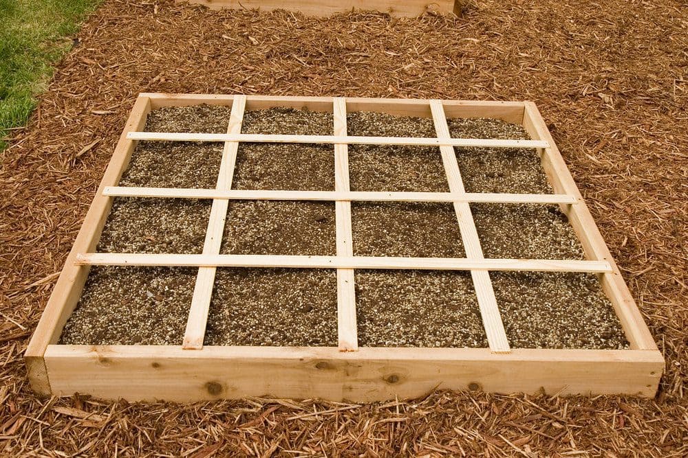 a square foot garden filled with a soil mixture