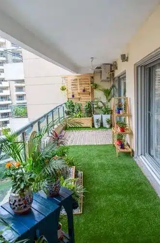 a terrace garden with pot planters and grass at the floor