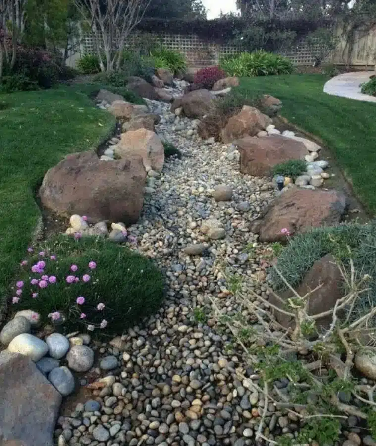 A view of a drey stream bed with stone inside a garden