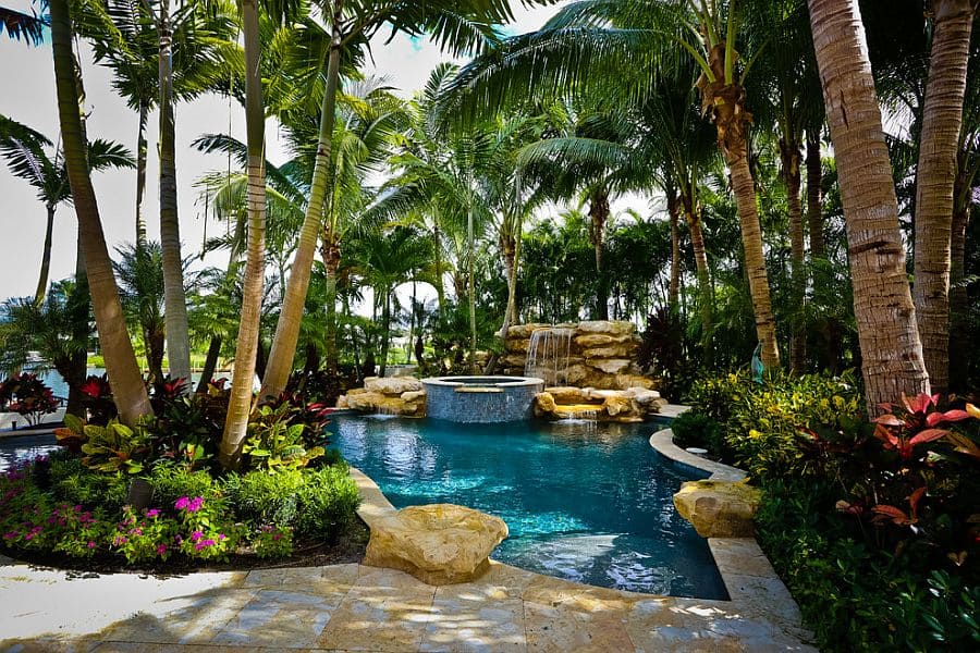 A view of a tropical garden around a pool area