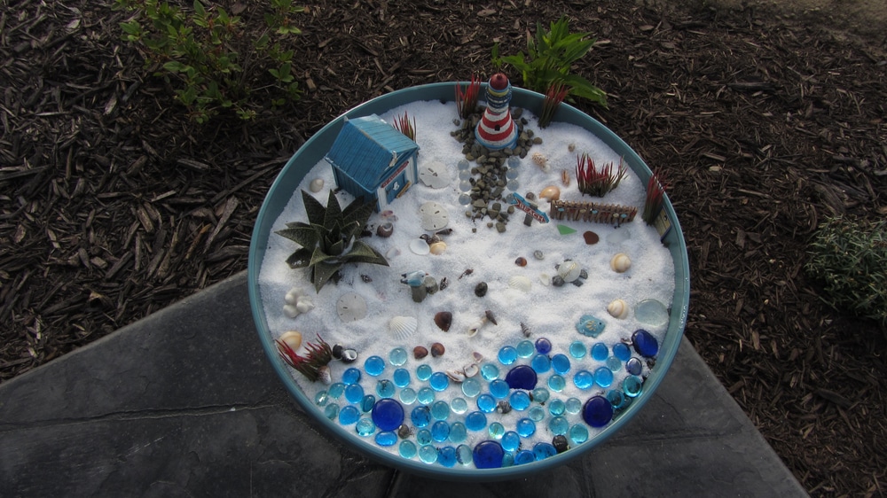 A view of a beach themed patio inside a garden